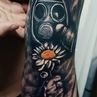 Unusual colored illustrative style sleeve tattoo of man in gas mask and small flower