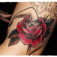 Unusual combined big red colored flower with womans leg tattoo on arm