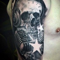 Unusual combined black ink microphone with skull and clock tattoo on half sleeve zone