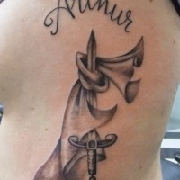 Unusual combined black ink sword with cloak tattoo on side combined with lettering