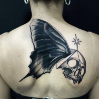 Unusual combined by Michele Zingales upper arm tattoo of human skull with butterfly wing