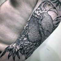 Unusual designed tribal style painted black ink crow tattoo on arm