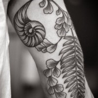 Unusual flower tattoo on arm by Kirsten