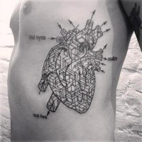 Unusual looking black ink side tattoo of human heart with schematics and lettering