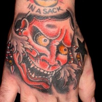 UOld school Asian traditional homemade painted colored arm tattoo of demonic face and stars