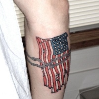 Usa flag with barbed wire tattoo on arm