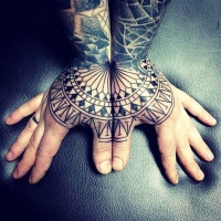 Usual black ink divided ornamental tribal tattoo on hands