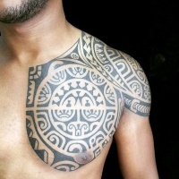 Usual black ink Polynesian style tattoo on chest and shoulder