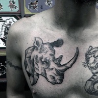 Usual black ink vintage style chest tattoo of rhino statue