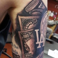 Usual colored and detailed dollar money bills tattoo on shoulder with old clock