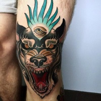 Usual designed and colored knee tattoo of demonic dog and eye