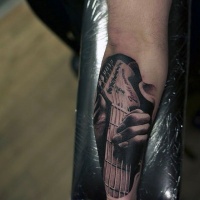 Usual designed black and white realistic guitar tattoo on arm
