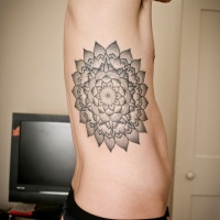 Usual designed black ink big flower tattoo on side