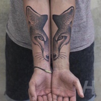 Usual designed divided fox head tattoo on forearm
