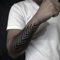 Usual dotwork style arm tattoo of arrow shaped ornament