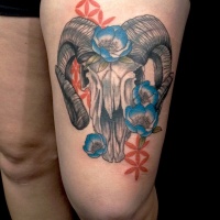 Usual large thigh tattoo of skull and flowers