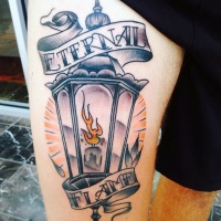 Usual old street lighter tattoo on arm combined with lettering