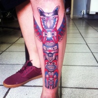 Usual style painted and colored big tribal statue tattoo on leg
