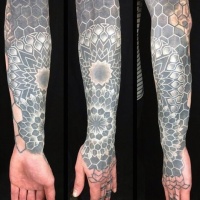 Usual style painted black and white floral ornaments tattoo on sleeve