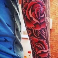 Usual style painted red colored big roses tattoo on arm