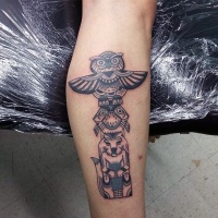 Usual tribal style old statue tattoo on arm
