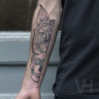 Valentin Hirsch typical black ink forearm tattoo of wild cat and human skull