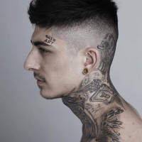 Various tattoos on whole body and lettering on forehead
