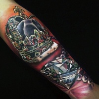 Very beautiful 3D like detailed and colored crown with diamond tattoo on arm