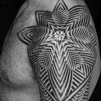 Very beautiful black and white tribal style flower tattoo on upper back zone