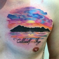 Very beautiful colorful mountains with lettering tattoo on chest