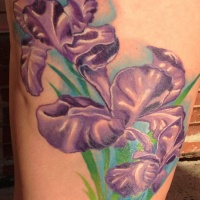 Very beautiful looking colored thigh tattoo of small flowers