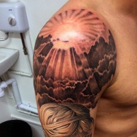 Very beautiful painted colored sunrise shoulder tattoo with clouds