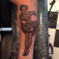 Very cute designed and colored sexy pin up girl tattoo on arm