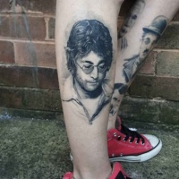 Very detailed black ink leg tattoo of famous musician portrait
