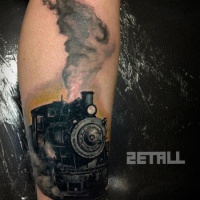 Very detailed leg tattoo of old steam train