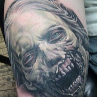Very realistic designed and detailed colored evil zombie woman tattoo on arm