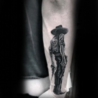 Very realistic looking 3D like black ink detailed cowboy with pistols tattoo on wrist
