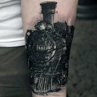 Very realistic looking amazing detailed colored old steamy train tattoo on arm