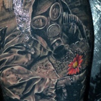 Very realistic looking arm tattoo of stalker with gas mask and small flower
