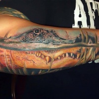 Very realistic looking big alligator head tattoo on arm