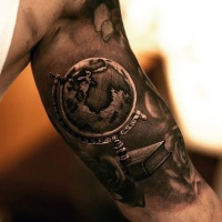 Very realistic looking black and white globe tattoo on arm