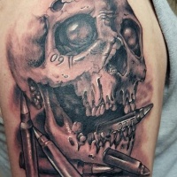 Very realistic looking black and white skull and bullets tattoo on upper arm