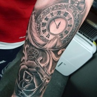 Very realistic looking black and white antic clock with feather and key tattoo on arm