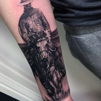 Very realistic looking black and white western cowboy tattoo on wrist