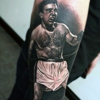 Very realistic looking black and white boxer tattoo on arm