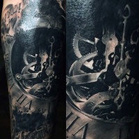 Very realistic looking black ink clock mechanism tattoo on arm