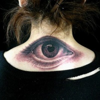 Very realistic looking detailed black and white eye tattoo on upper back