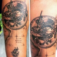 Very realistic looking detailed black and white antic compass with map tattoo on arm