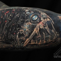 Very realistic looking great detailed creepy alien like fish tattoo on arm