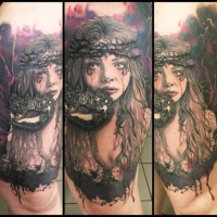 Very realistic looking horror style woman with mask tattoo on thigh